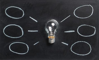 light bulb with black background and thought bubbles